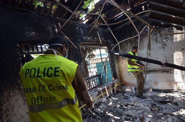 Sri Lankan police look at a burnt home in Digana, a suburb of Kandy, on Thursday. Sri Lankan police said petrol bombs were hurled at a mosque as hundreds of troops patrolled a troubled central district where anti-Muslim violence has left three people dead. (AFP) Sri Lankan police look at a burnt home in Digana, a suburb of Kandy, on Thursday. Sri Lankan police said petrol bombs were hurled at a mosque as hundreds of troops patrolled a troubled central district where anti-Muslim violence has left three people dead. (AFP)