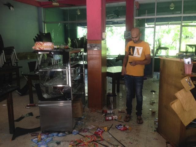 Mohamed Ramzeen in his vandalised restaurant in Pilimathalawa, Sri Lanka, on Thursday. About 50 people broke into Ramzeen's restaurant on Wednesday night while the curfew was in effect, destroying nearly everything they found, he said. (AP) Mohamed Ramzeen in his vandalised restaurant in Pilimathalawa, Sri Lanka, on Thursday. About 50 people broke into Ramzeen's restaurant on Wednesday night while the curfew was in effect, destroying nearly everything they found, he said. (AP)