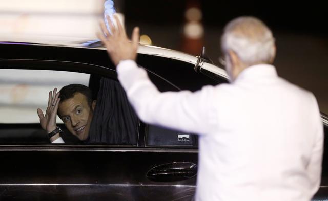 French President Emmanuel Macron waves towards Prime Minister Narendra Modi as he drives away after arriving at Air Force Station Palam in New Delhi, on March 9, 2018. (Reuters) French President Emmanuel Macron waves towards Prime Minister Narendra Modi as he drives away after arriving at Air Force Station Palam in New Delhi, on March 9, 2018. (Reuters)