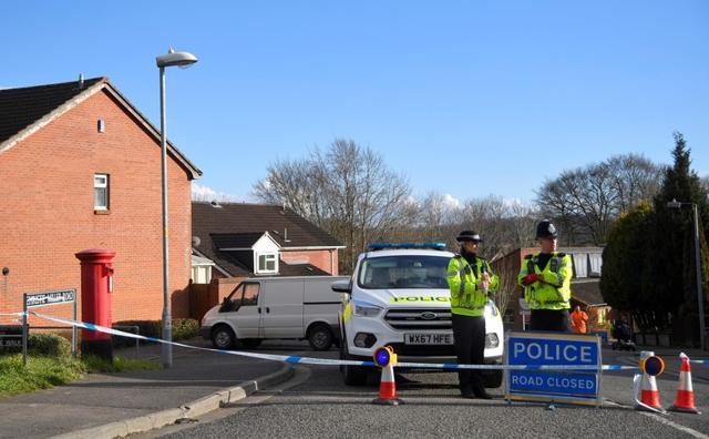 Police officers seal off the road on which former Russian spy Sergei Skripal lives in Salisbury, Britain, on March 7, 2018. (Reuters)