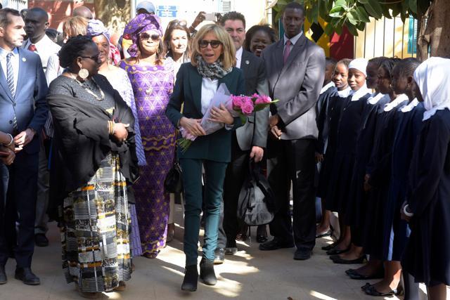 Macron also often accessorises her outfits with scarves. (AFP/ Seyllou) Macron also often accessorises her outfits with scarves. (AFP/ Seyllou)