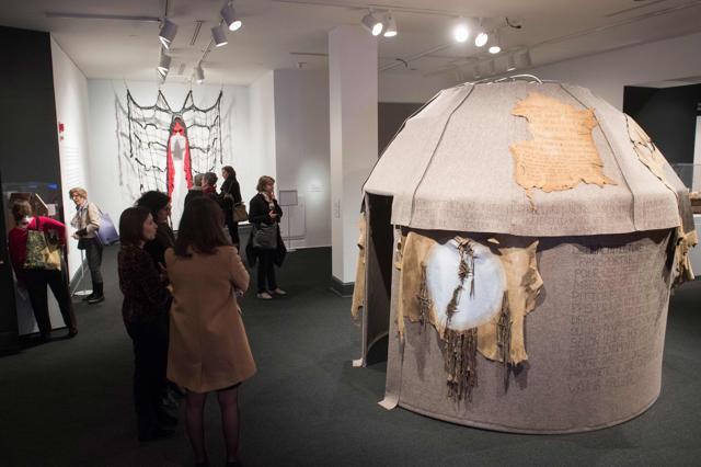 Museum guests walk past a yurt titled Topak Ev, by artist Nil Yalter. (AFP)