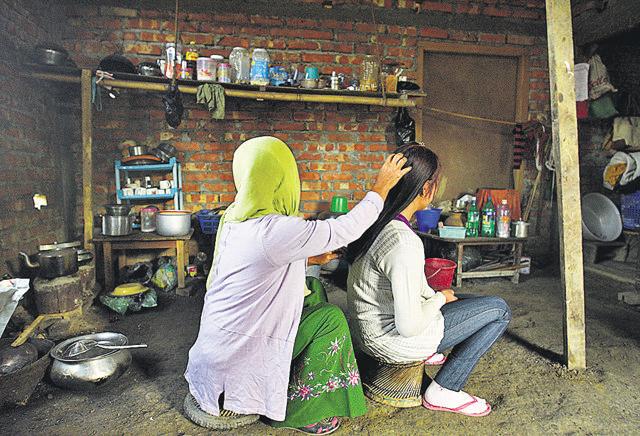 One of the Manipuri girls who was rescued from Yangon in 2017, at home with her mother. The promise of a job as a housemaid or in a salon in Southeast Asia or the Gulf, with the prospect of a good salary, is tempting for the girls and their families, since most of them are not very well off. (Vipin Kumar/HT PHOTO)