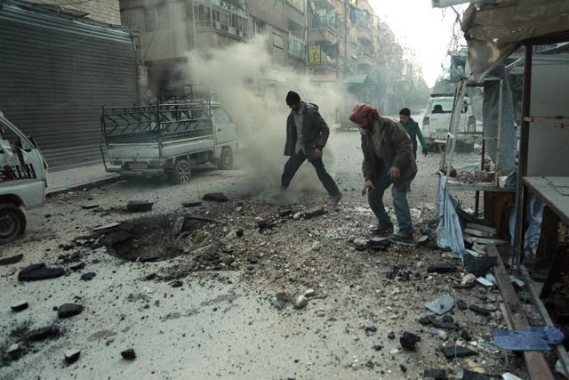 Syrian men check the damage following Syrian government shelling on the town of Douma. (AFP Photo) Syrian men check the damage following Syrian government shelling on the town of Douma. (AFP Photo)