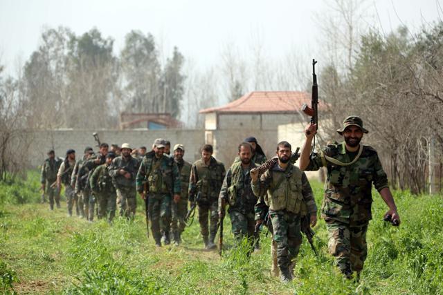 Syrian regime forces are pictured in the town of Aftris, west of the rebel-held town of Saqba, in the besieged Eastern Ghouta region on the outskirts of the capital Damascus (AFP Photo) Syrian regime forces are pictured in the town of Aftris, west of the rebel-held town of Saqba, in the besieged Eastern Ghouta region on the outskirts of the capital Damascus (AFP Photo)