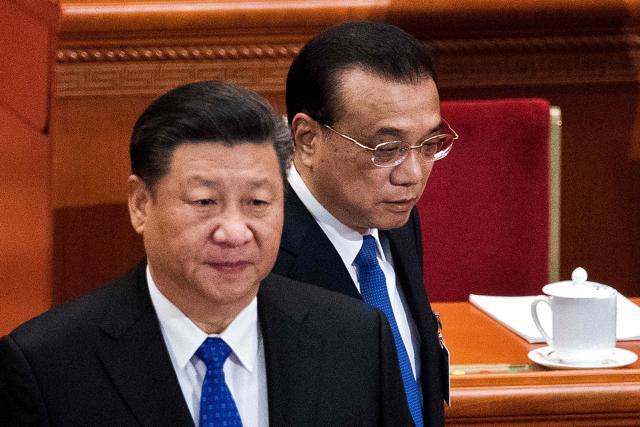 China's President Xi Jinping (L) and Premier Li Keqiang (R) arrive for the fourth plenary session of the National People's Congress (NPC) at the Great Hall of the People in Beijing. (AFP) China's President Xi Jinping (L) and Premier Li Keqiang (R) arrive for the fourth plenary session of the National People's Congress (NPC) at the Great Hall of the People in Beijing. (AFP)