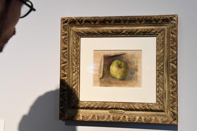 A man looks at the painting "Pomme" 1914 by late Spanish painter Pablo Picasso. (AFP/Bertrand Guay) A man looks at the painting "Pomme" 1914 by late Spanish painter Pablo Picasso. (AFP/Bertrand Guay)