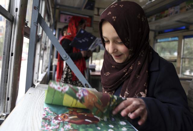 Marwa, 11, looks at a book inside the library. (AP Photo/Rahmat Gul) Marwa, 11, looks at a book inside the library. (AP Photo/Rahmat Gul)