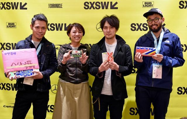 The team behind the film pose with Fuyuki Shimazu and his products. (REUTERS)