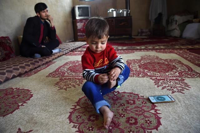 This picture taken on March 16, 2018 shows Afghan father Sayed Assadullah Pooya, 28, looking on alongside his son Donald Trump, aged around 18 months, during an interview with AFP at their home in Kabul. (AFP) This picture taken on March 16, 2018 shows Afghan father Sayed Assadullah Pooya, 28, looking on alongside his son Donald Trump, aged around 18 months, during an interview with AFP at their home in Kabul. (AFP)