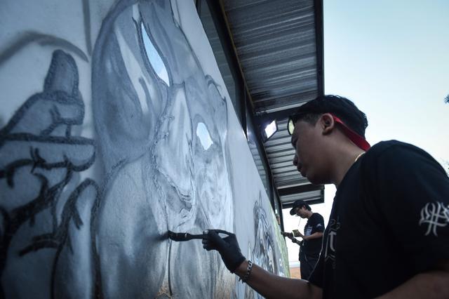 Bangkok graffiti artists painted a mural on March 16 of panthers seated at a "Last Supper" table. (AFP) Bangkok graffiti artists painted a mural on March 16 of panthers seated at a "Last Supper" table. (AFP)
