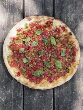 Strazzata, a summer-style pizza with peppers, tomato, and extra virgin olive oil, from Ristorante Pizzeria il Fosso, a small shack in a forest near the Basilicata village of Noepoli. (Bloomberg) Strazzata, a summer-style pizza with peppers, tomato, and extra virgin olive oil, from Ristorante Pizzeria il Fosso, a small shack in a forest near the Basilicata village of Noepoli. (Bloomberg)