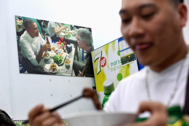 A customer enjoys a meal at Bun Cha Huong Lien restaurant, now dubbed "bun cha Obama" with a photograph of former US President Barack Obama displayed on the wall, in Hanoi's old quarter. (AFP) A customer enjoys a meal at Bun Cha Huong Lien restaurant, now dubbed "bun cha Obama" with a photograph of former US President Barack Obama displayed on the wall, in Hanoi's old quarter. (AFP)