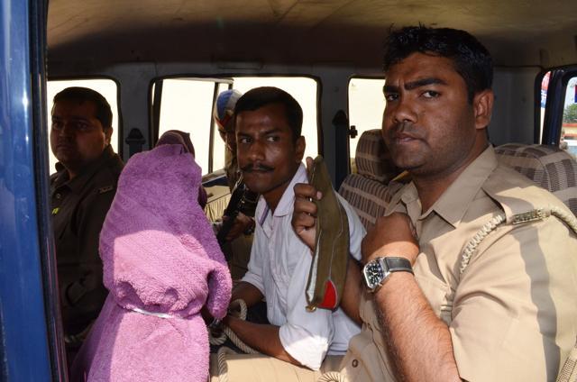 The accused Dhruv Kumar (in white) in police custody. (HT Photo)