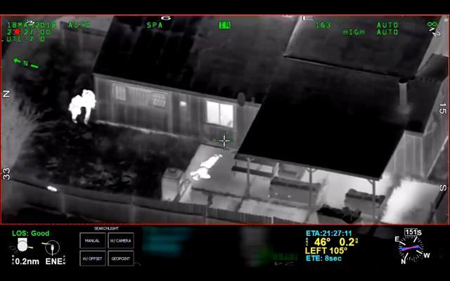 Stephon Clark, 22, is visible on the ground after two police officers (left) shot him, in this still image captured from police aerial video footage released by Sacramento Police Department. (Reuters Photo)