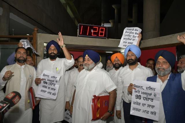 Opposition Shiromani Akali Dal legislators raising slogans as they stage walkout from Punjab assembly during presentation of annual budget in Chandigarh on Saturday. (Keshav Singh/HT) Opposition Shiromani Akali Dal legislators raising slogans as they stage walkout from Punjab assembly during presentation of annual budget in Chandigarh on Saturday. (Keshav Singh/HT)