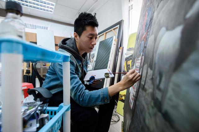 Oil painter Ray Chow, 31, paints in a subdivided flat, which he and another artist have rented to use as their art studio. (AFP) Oil painter Ray Chow, 31, paints in a subdivided flat, which he and another artist have rented to use as their art studio. (AFP)