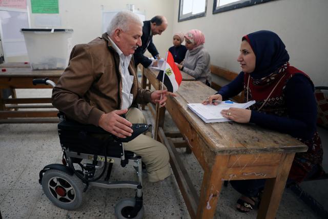 A man in a wheelchair arrives to cast his vote during the presidential election in Alexandria, Egypt on March 26. (REUTERS) A man in a wheelchair arrives to cast his vote during the presidential election in Alexandria, Egypt on March 26. (REUTERS)