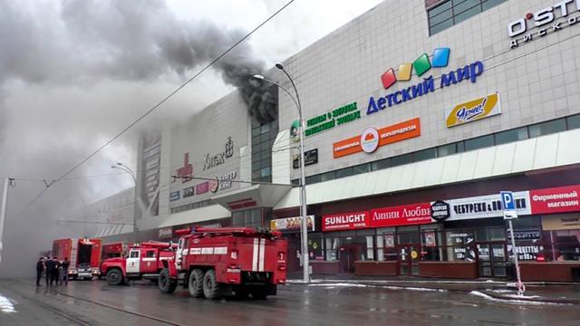 Emergency vehicles gather outside a burning shopping centre in Kemerovo. (AFP) Emergency vehicles gather outside a burning shopping centre in Kemerovo. (AFP)