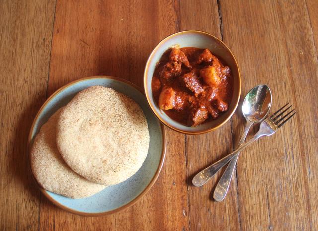 The pork vindaloo is tangy and spicy, but not unpleasantly pungent. The accompanying poie were soft, fluffy and did a good job of mopping up the gravy. (Photo by Bhushan Koyande/HT Photo)
