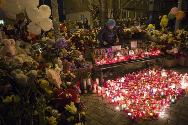A woman lights candles by a floral tribute for the victims of Sunday's fire in Kemerova. (AP Photo) A woman lights candles by a floral tribute for the victims of Sunday's fire in Kemerova. (AP Photo)
