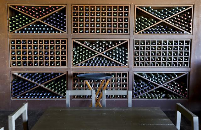 Bottles of wine line the wall of the dining room at Viu Manet vineyard. (AP Photo/Esteban Felix) Bottles of wine line the wall of the dining room at Viu Manet vineyard. (AP Photo/Esteban Felix)