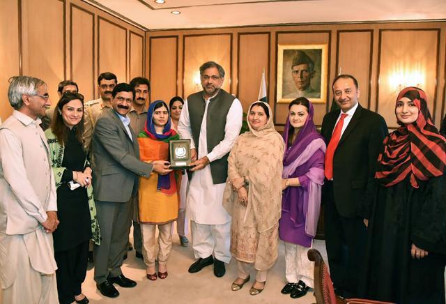 This handout photograph released by the Press Information Department (PID) on March 29, 2018, shows Pakistani Prime Minister Shahid Khaqan Abbasi (C) presenting a shield to Pakistani activist and Nobel Peace Prize laureate Malala Yousafza (4L) at the Prime Minister Office during her visit to Islamabad. (AFP) This handout photograph released by the Press Information Department (PID) on March 29, 2018, shows Pakistani Prime Minister Shahid Khaqan Abbasi (C) presenting a shield to Pakistani activist and Nobel Peace Prize laureate Malala Yousafza (4L) at the Prime Minister Office during her visit to Islamabad. (AFP)