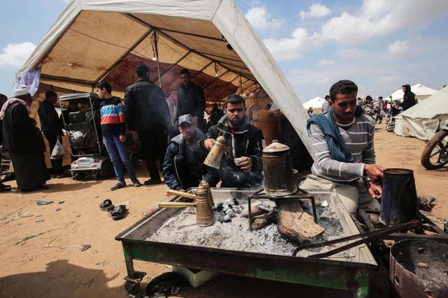 Palestinian protesters make traditional coffee as they hold a demonstration commemorating Land Day, near the border with Israel, east of Khan Yunis, in the southern Gaza Strip. (AFP) Palestinian protesters make traditional coffee as they hold a demonstration commemorating Land Day, near the border with Israel, east of Khan Yunis, in the southern Gaza Strip. (AFP)