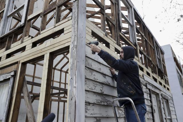 American artist Ryan Mendoza dismantles the rebuilt house of civil rights activist Rosa Parks in Berlin. (AP) American artist Ryan Mendoza dismantles the rebuilt house of civil rights activist Rosa Parks in Berlin. (AP)