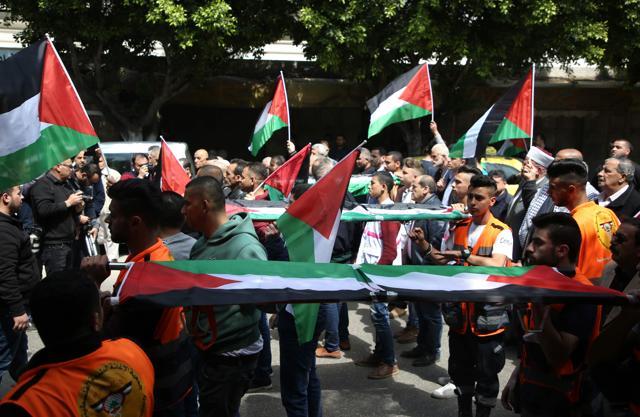 Palestinian men march in the Israeli occupied West Bank city of Nablus in a symbolic funeral in solidarity with those who were killed a day earlier in the Gaza Strip during clashes with Israeli forces on Land Day. (AFP) Palestinian men march in the Israeli occupied West Bank city of Nablus in a symbolic funeral in solidarity with those who were killed a day earlier in the Gaza Strip during clashes with Israeli forces on Land Day. (AFP)