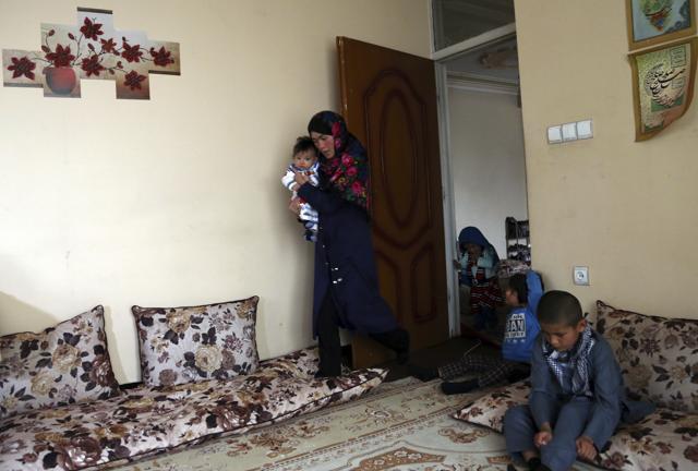 Jahantab Ahmadi, 25, holding her three month-old daughter Khezran arrives for an interview in Kabul on March 26. (AP Photo) Jahantab Ahmadi, 25, holding her three month-old daughter Khezran arrives for an interview in Kabul on March 26. (AP Photo)
