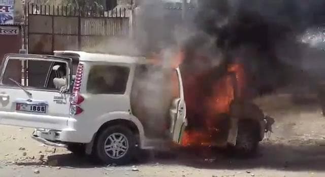 A vehicle set on fire by protesters in Barmer on Monday. (HT Photo) A vehicle set on fire by protesters in Barmer on Monday. (HT Photo)