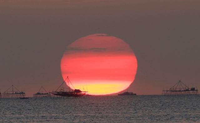 Houses on stilts are seen as the sun sets around the Manila bay in Manila, Philippines. (REUTERS File) Houses on stilts are seen as the sun sets around the Manila bay in Manila, Philippines. (REUTERS File)