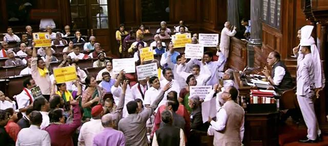 Opposition members protest in the Well of the Rajya Sabha on Thursday. (PTI) Opposition members protest in the Well of the Rajya Sabha on Thursday. (PTI)