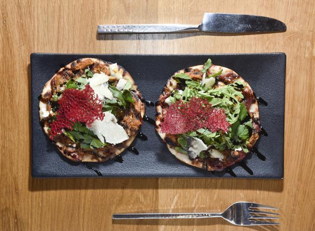 The duo of red-wine duck kulchas with a cranberry sauce topping was overly sweet. Sinewy bits of duck sat atop soggy mini kulchas, making for messy dissatisfaction. (Aalok Soni / HT Photo)
