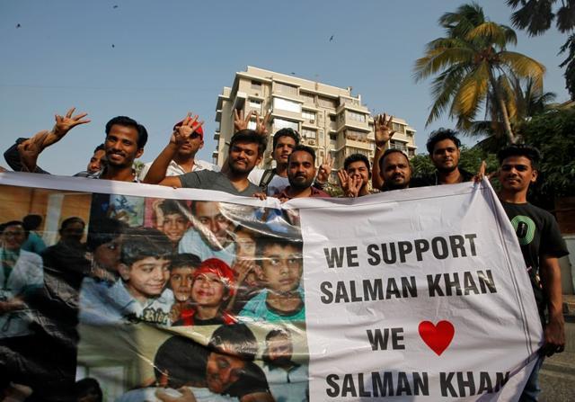 Fans of Salman Khan pose as they hold a banner outside his house. (REUTERS) Fans of Salman Khan pose as they hold a banner outside his house. (REUTERS)
