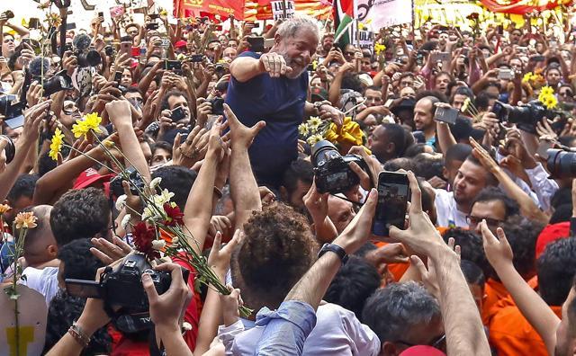 Brazilian ex-president (2003-2011) Luiz Inacio Lula da Silva waves to supporters after attending a Catholic Mass in memory of his late wife Marisa Leticia, at the metalworkers' union building in Sao Bernardo do Campo, in Sao Paulo, Brazil, on April 7, 2018. Brazil's election frontrunner and controversial leftist icon said on Saturday that he will comply with an arrest warrant to start a 12-year sentence for corruption. (AFP) Brazilian ex-president (2003-2011) Luiz Inacio Lula da Silva waves to supporters after attending a Catholic Mass in memory of his late wife Marisa Leticia, at the metalworkers' union building in Sao Bernardo do Campo, in Sao Paulo, Brazil, on April 7, 2018. Brazil's election frontrunner and controversial leftist icon said on Saturday that he will comply with an arrest warrant to start a 12-year sentence for corruption. (AFP)