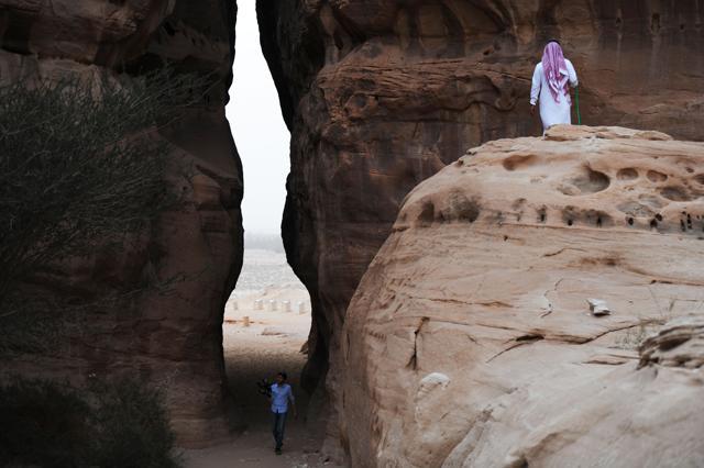 A picture taken on March 31, 2018 shows a Saudi man and journalist visiting the Madain Saleh, a UNESCO World Heritage site, near Saudi Arabia's northwestern town of al-Ula. (AFP)
