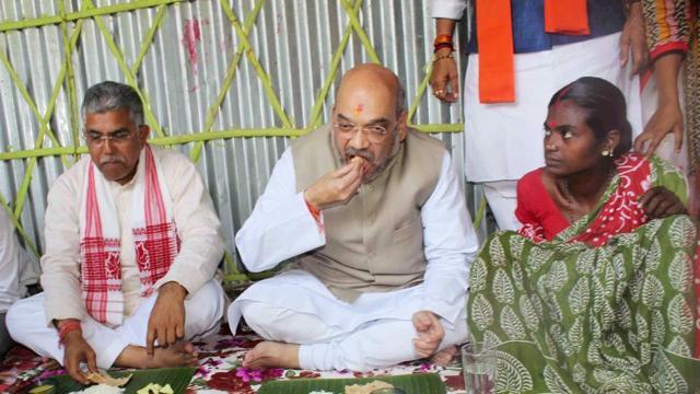 BJP president Amit Shah and the party’s Bengal unit chief Dilip Ghosh having lunch at a scheduled tribe couple’s hut in Naxalbari in north Bengal in May 2017. (HT Photo) BJP president Amit Shah and the party’s Bengal unit chief Dilip Ghosh having lunch at a scheduled tribe couple’s hut in Naxalbari in north Bengal in May 2017. (HT Photo)