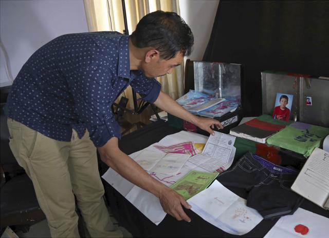 Project organiser Salim Rajabi arranges mementos of Sayed Baqir, one of Afghanistan's war dead, who was killed in a suicide attack. (AP) Project organiser Salim Rajabi arranges mementos of Sayed Baqir, one of Afghanistan's war dead, who was killed in a suicide attack. (AP)