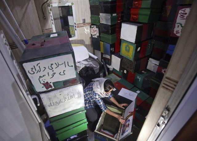Zahra Hossaini, a member of the Afghanistan Human Rights and Democracy Organization, arranges "memory boxes" in Kabul, Afghanistan. (AP) Zahra Hossaini, a member of the Afghanistan Human Rights and Democracy Organization, arranges "memory boxes" in Kabul, Afghanistan. (AP)