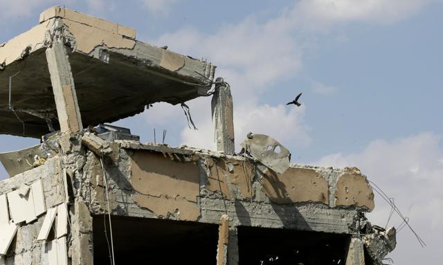 This picture taken on April 14, 2018 shows the wreckage of a building described as part of the Scientific Studies and Research Centre (SSRC) compound in the Barzeh district. (AFP)