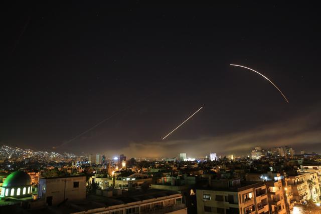 Missiles streak across the Damascus skyline as the US launches an attack on Syria targeting different parts of the capital, early on Saturday. (AP Photo) Missiles streak across the Damascus skyline as the US launches an attack on Syria targeting different parts of the capital, early on Saturday. (AP Photo)