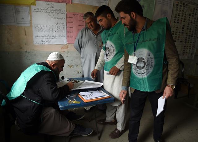 This photo taken on April 14, 2018 shows Afghan employees of the Independent Election Commission (IEC) registering a resident at a voter registration center for the upcoming parliamentary and district council elections in Kabul. (AFP) This photo taken on April 14, 2018 shows Afghan employees of the Independent Election Commission (IEC) registering a resident at a voter registration center for the upcoming parliamentary and district council elections in Kabul. (AFP)