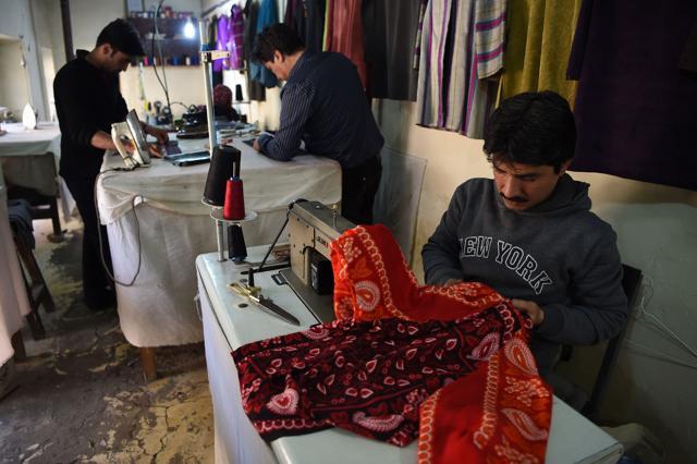 Afghan tailors sewing clothes at Zarif Design House in Kabul. (AFP) Afghan tailors sewing clothes at Zarif Design House in Kabul. (AFP)