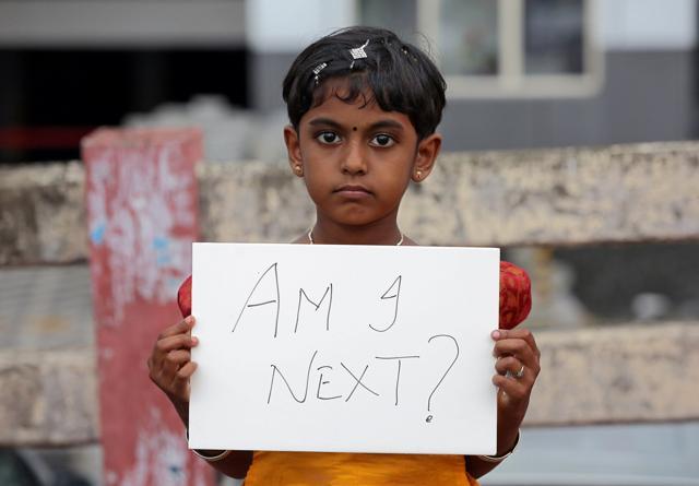 A gild holds a placard during a protest against the rape of an eight-year-old girl in Kathua, in Kochi. (Reuters) A gild holds a placard during a protest against the rape of an eight-year-old girl in Kathua, in Kochi. (Reuters)