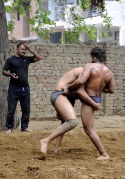Coach Surendra Singh Yadav, an army veteran, trains young wrestlers in Sarfabad in a bid to sustain the wrestling culture of the village. (Sunil Ghosh/HT Photo)