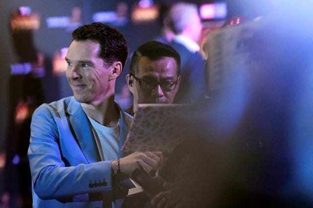 Benedict Cumberbatch signs autographs on the red carpet. (REUTERS)