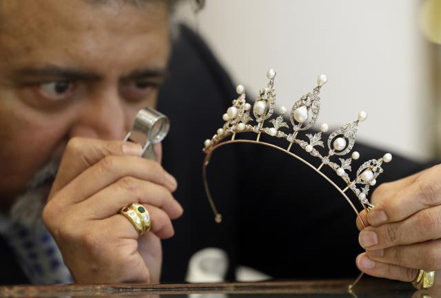 Omar Vaja, director of sales inspects a late Victorian pearl and diamond tiara circa 1890 at Bradley & Skinner, an antique & period jewellery specialist in London. (AP) Omar Vaja, director of sales inspects a late Victorian pearl and diamond tiara circa 1890 at Bradley & Skinner, an antique & period jewellery specialist in London. (AP)