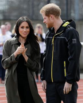 Britain's Prince Harry (R) and his fiancee US actress Meghan Markle (L) meet participants as they attend the UK team trials for the Invictus Games Sydney 2018 at the University of Bath Sports Training Village in Bath, southwest England on April 6, 2018. (AFP)